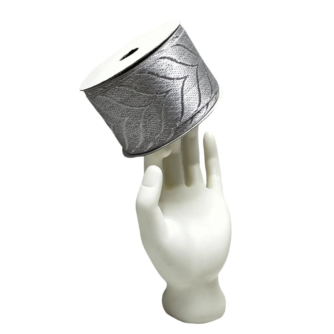 Decorative lampshade with leaf pattern on a white mannequin head against a white background